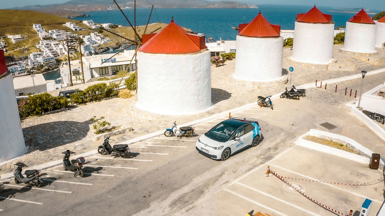 A Volkswagen ID.3 drives past the famous windmills on Mykonos.