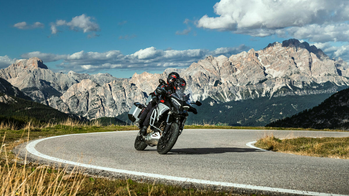 Ducati in a bend in front of mountains