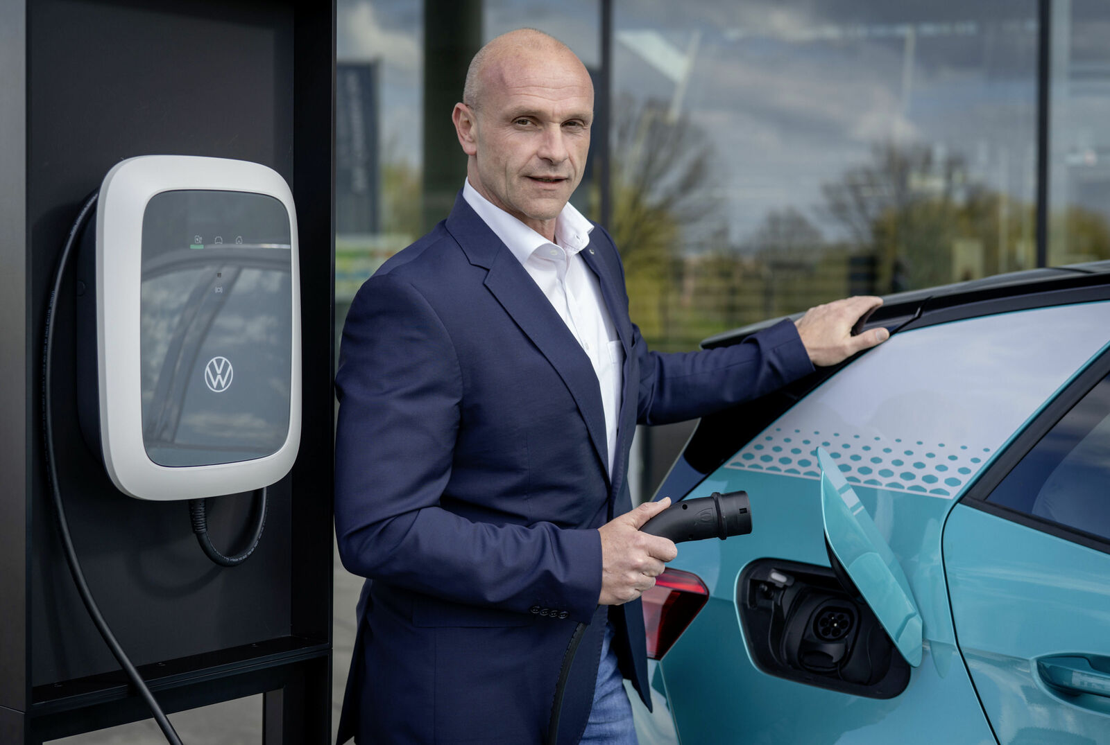 Thomas Ulbrich, Chief Technology Officer (CTO) Volkswagen Group China standing at a charging station