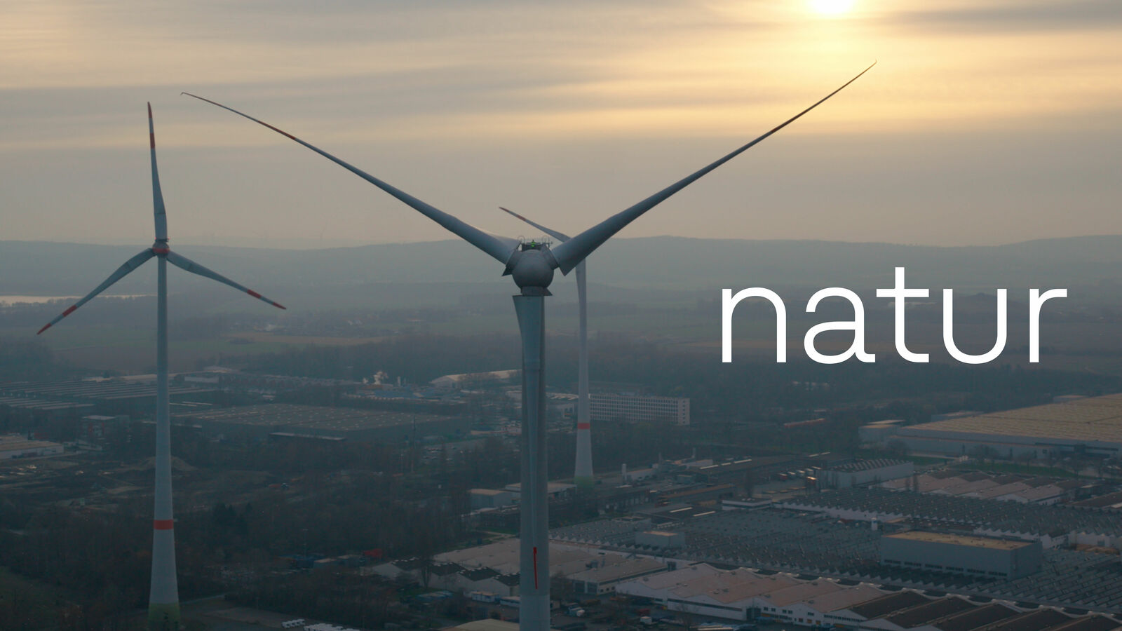 Windkraftanlagen bei Sonnenuntergang, darüber steht das Wort "natur".