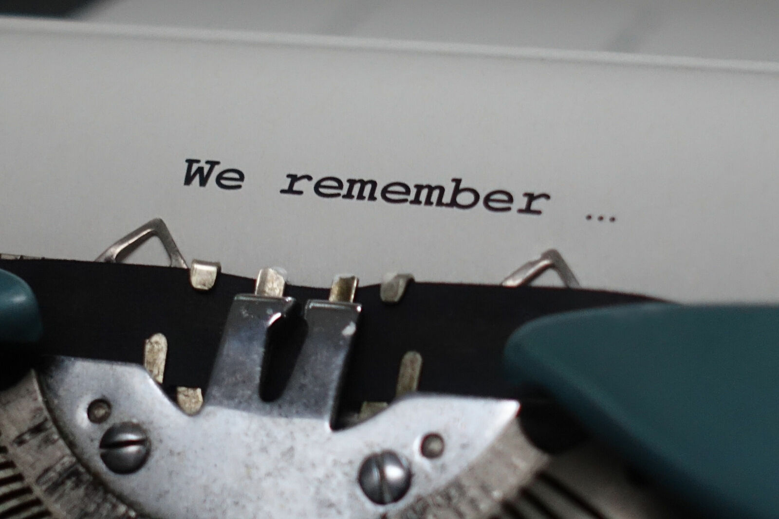 Close-up of a typewriter with the words "We remember …" typed on the paper.