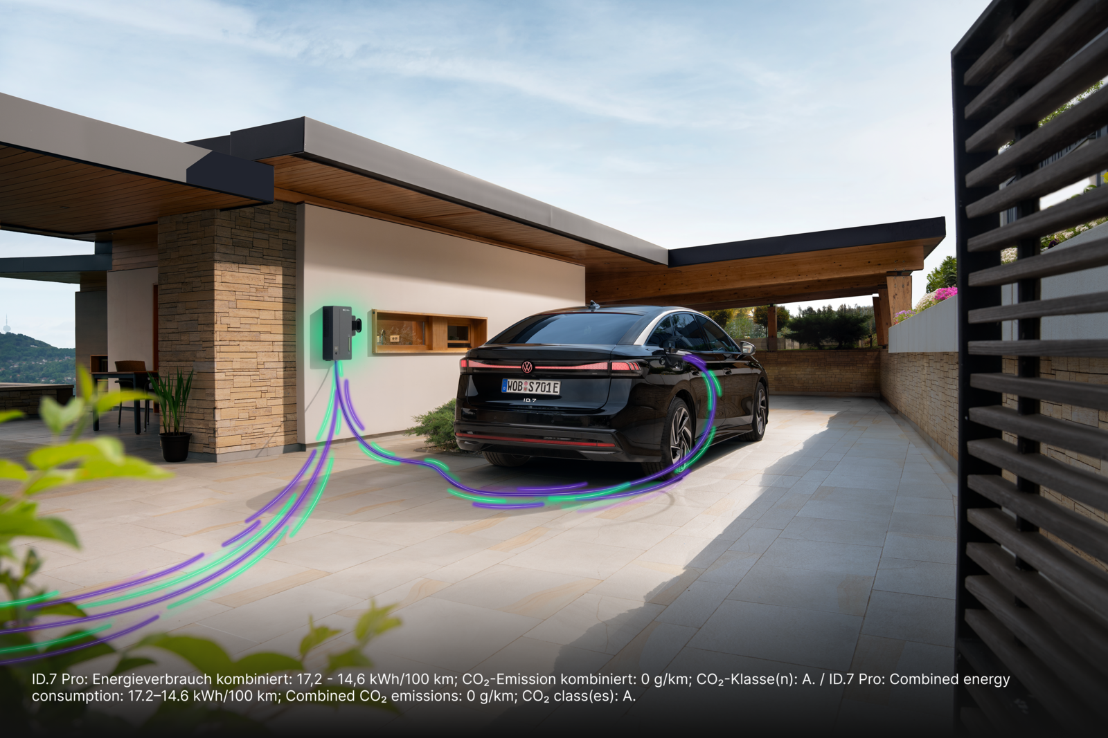 Black electric car charging at a home wallbox in a modern house driveway