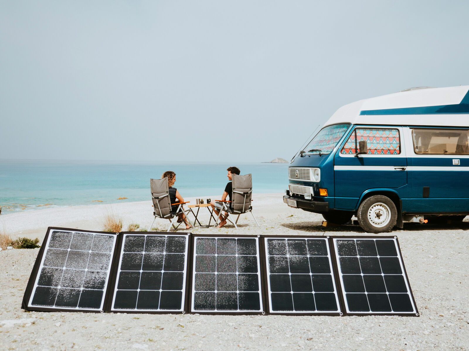 VW T3 with solar panels on beach